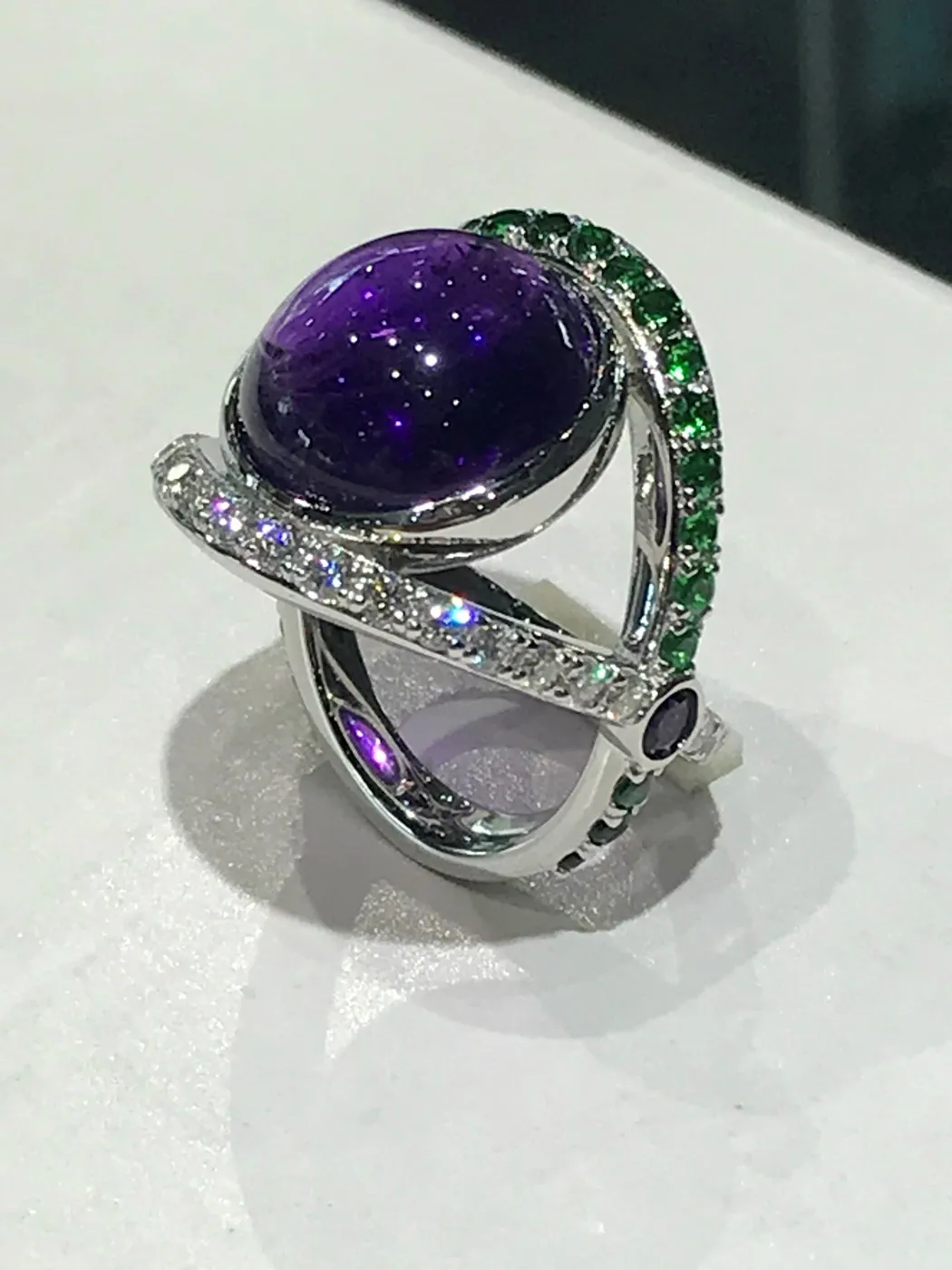 The finished amethyst and green stone ring